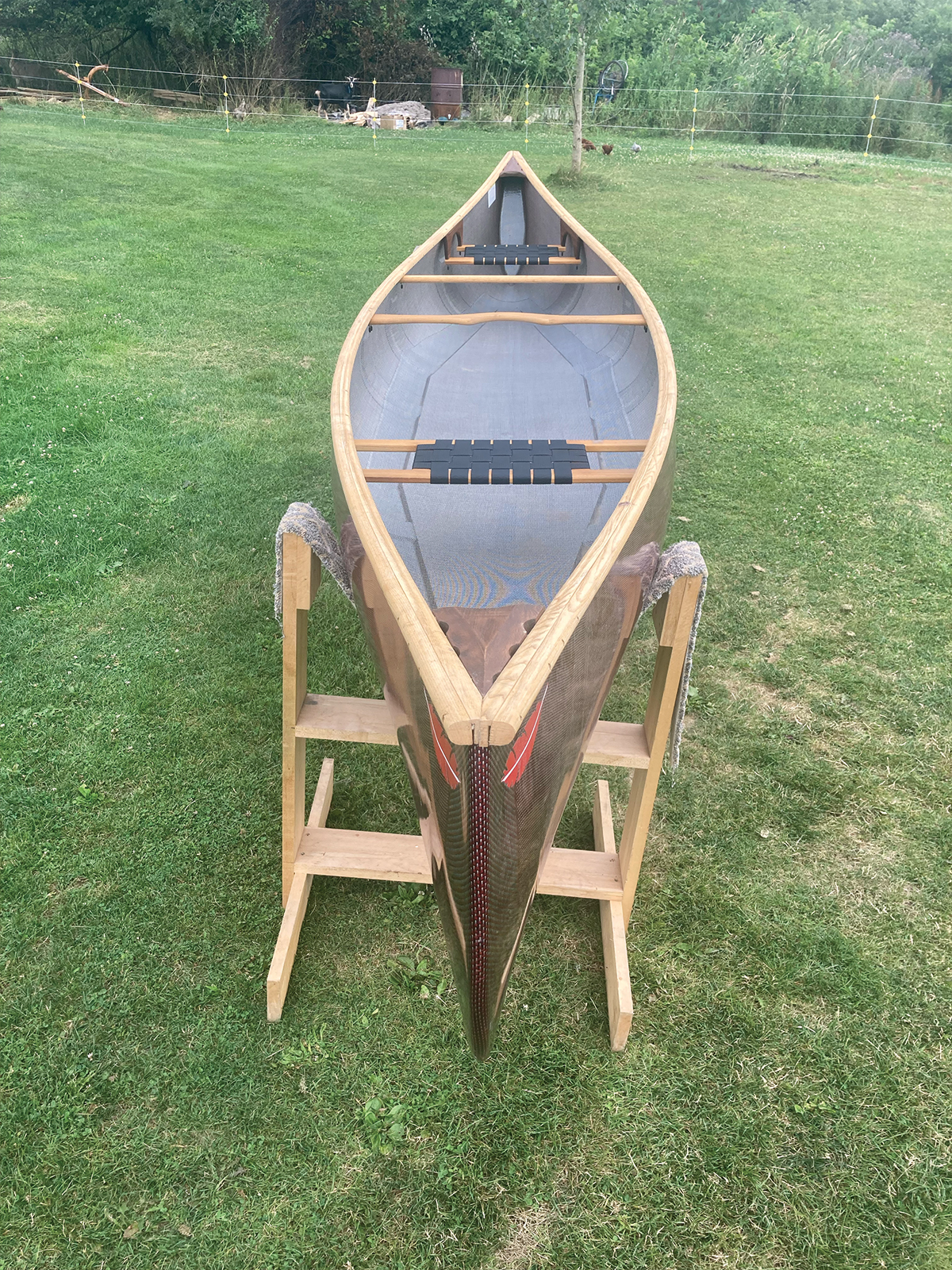 Overhead, bow to stern view of Redfeather Prospector with red hull and ash gunwales