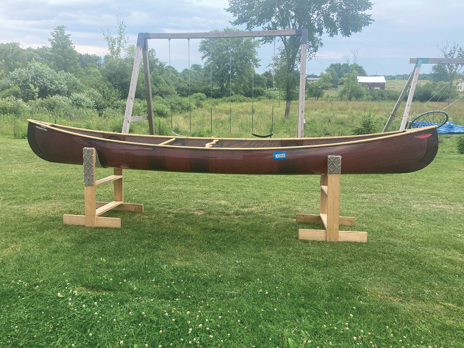 Starboard view of Redfeather Prospector with red hull and ash gunwales
