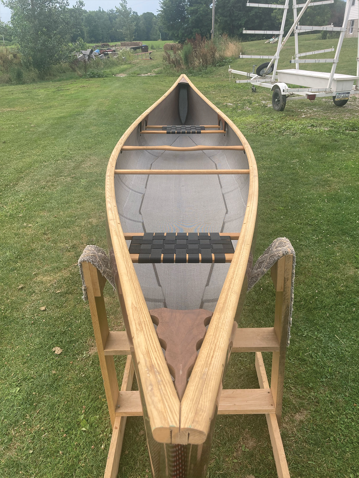 Overhead, stern to bow view of Redfeather Prospector with red hull and ash gunwales